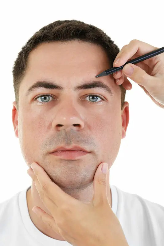 A man having his eyebrows microbladed